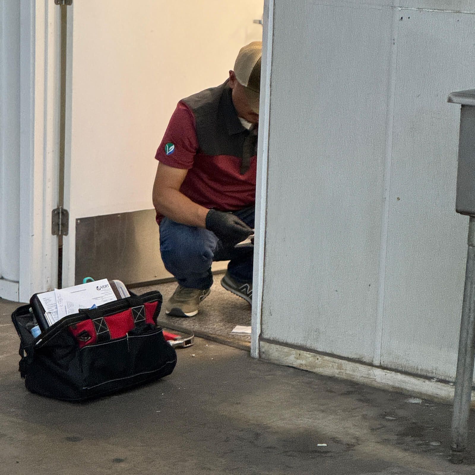 Specialist conducting a precise material inspection during an environmental site safety audit.