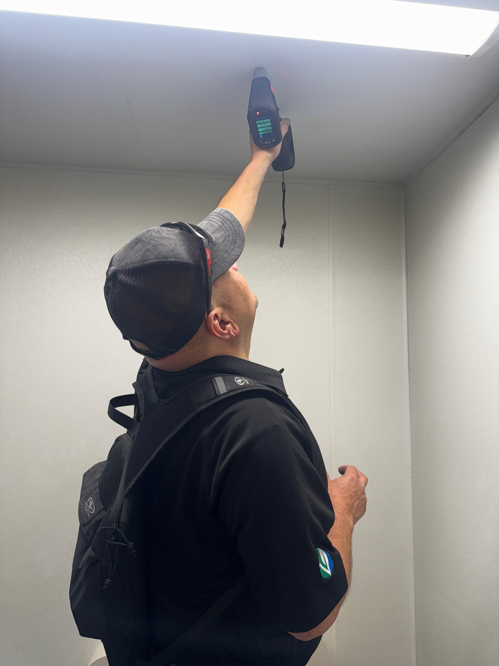 Vert Environmental specialist monitoring XRF device readouts during a lead-paint inspection.