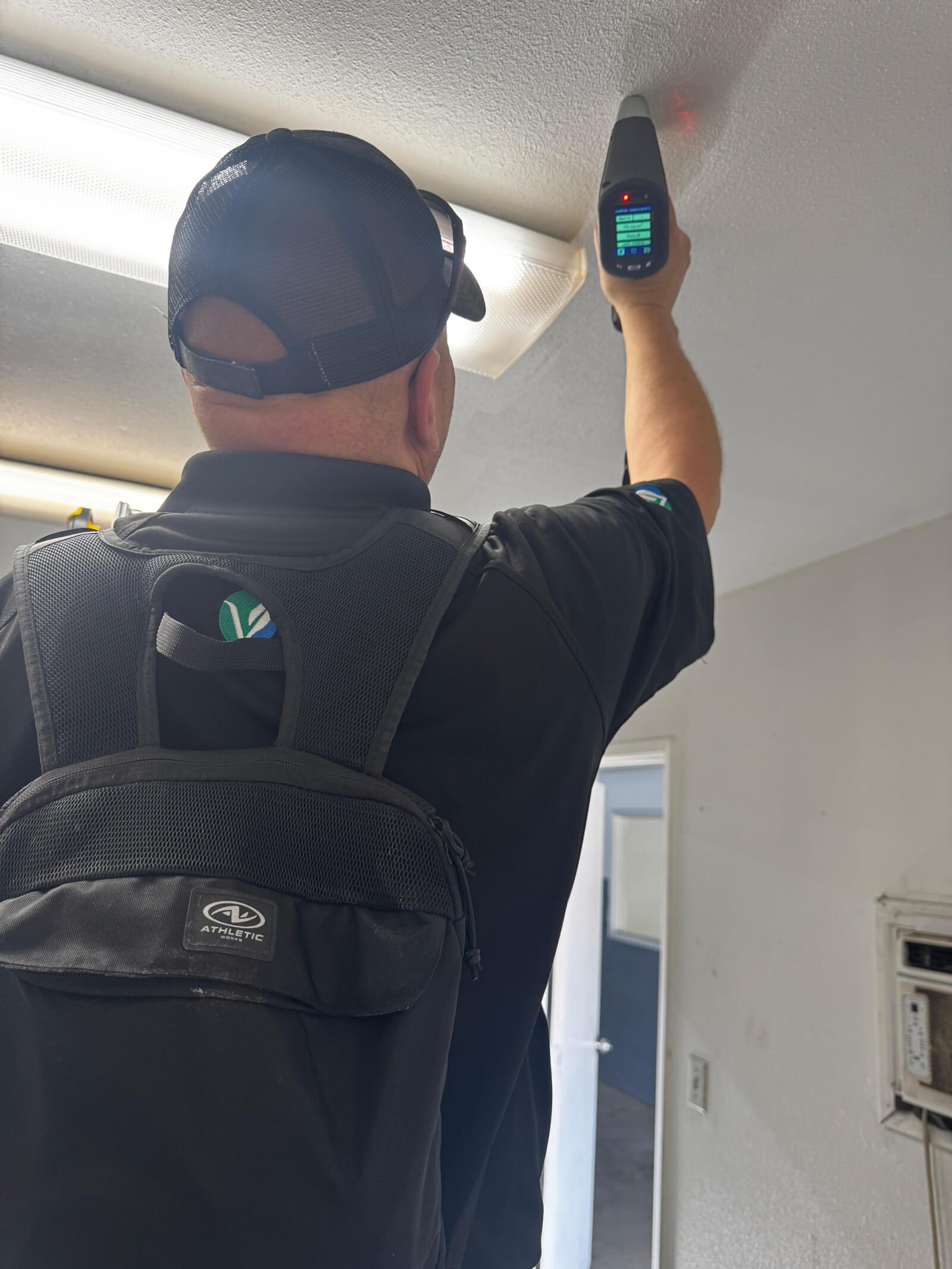 Vert Environmental specialist monitoring XRF device readouts during a lead-paint inspection.