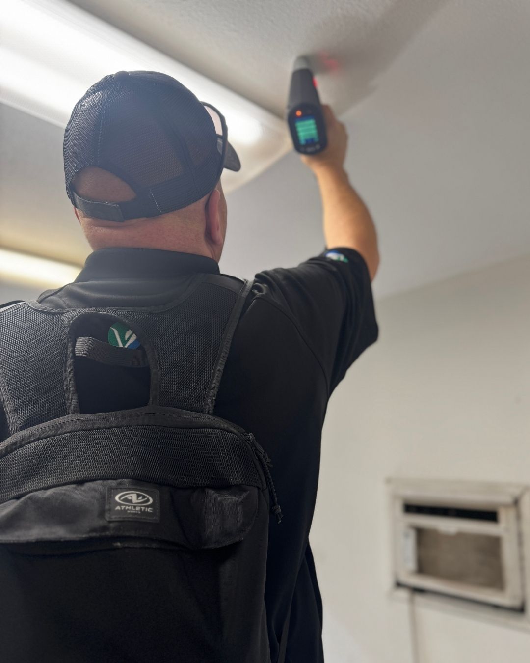 user-inserted Vert Environmental technician using advanced equipment to assess potential environmental hazards in a building. Demonstrating efficient response and service for environmental testing and safety evaluations.