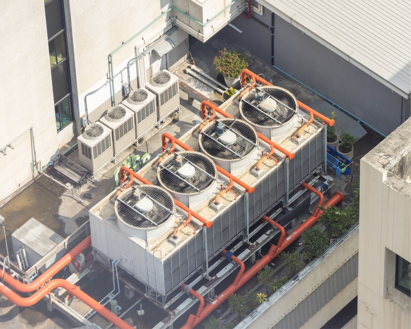 user-inserted Rooftop commercial HVAC cooling tower with fans and piping for Legionella water testing, maintenance, and building safety compliance.