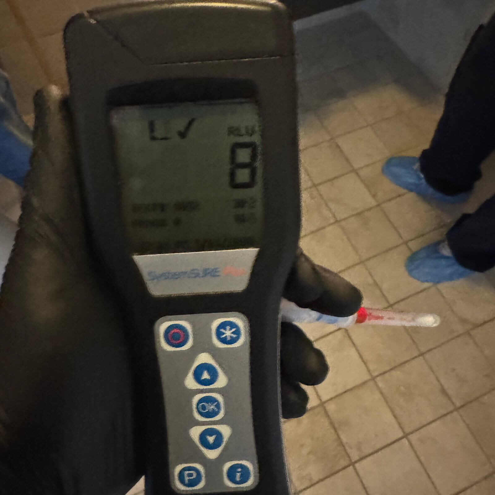 Handheld ATP hygiene monitoring device displaying on-site bacterial test results.
